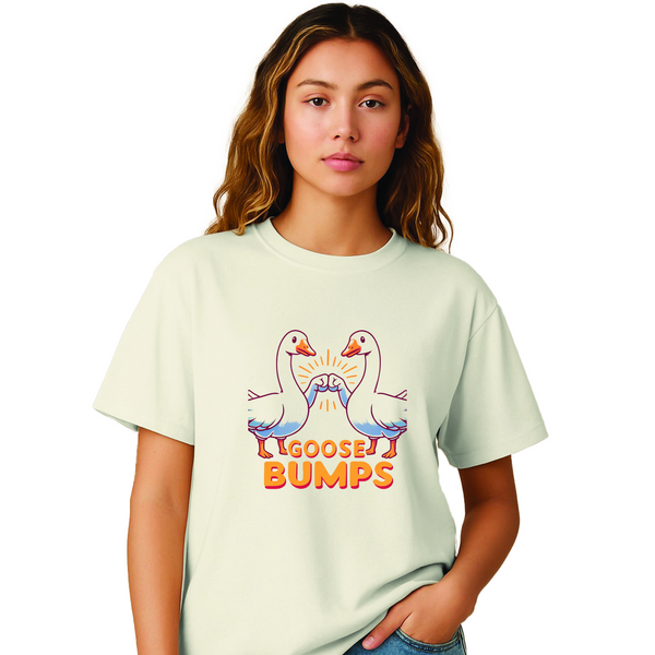 Woman wearing a light oversized T-shirt featuring two geese fist-bumping with the slogan "Goose Bumps